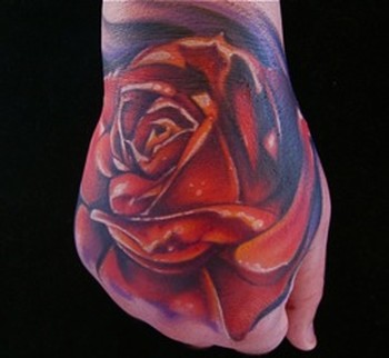 Mike Demasi - color red rose hand tattoo.