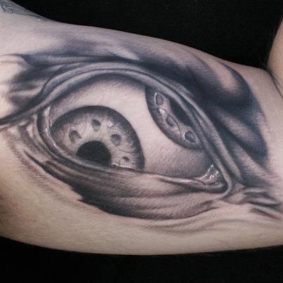Ryan Mullins - black and grey realistic alien eye tattoo