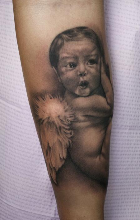 Ryan Mullins - Realistic black and gray portrait of baby with angel wings. Ryan Mullins Art Junkies Tattoo