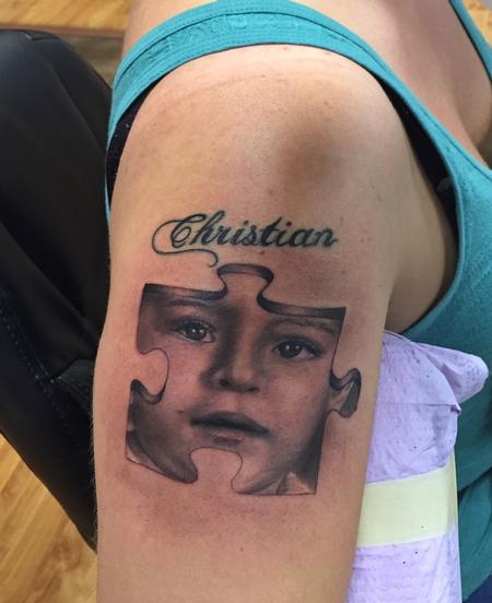 Ryan Mullins - Realistic black and gray portrait in a puzzle piece tattoo. Ryan Mullins Art Junkies Tattoo