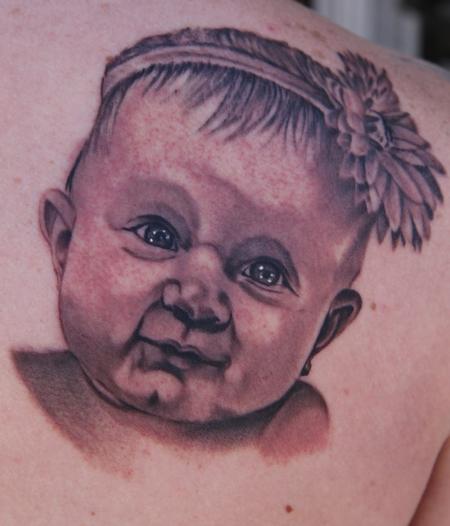 Black and Grey realistic baby portrait tattoo