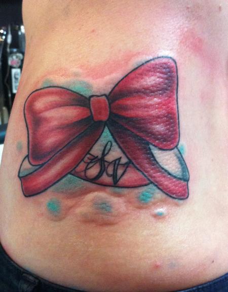 Mike Riedl - traditional red bow tattoo