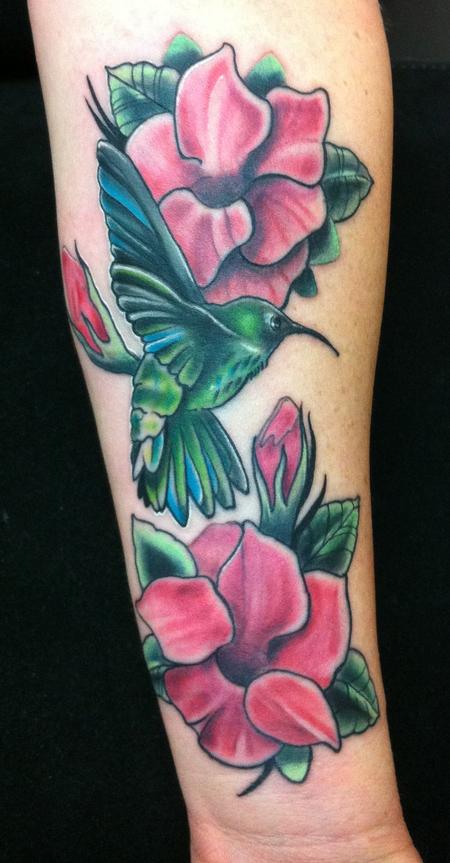 Mike Riedl - colored humming bird with crimson mandevilla flowers tattoo. 