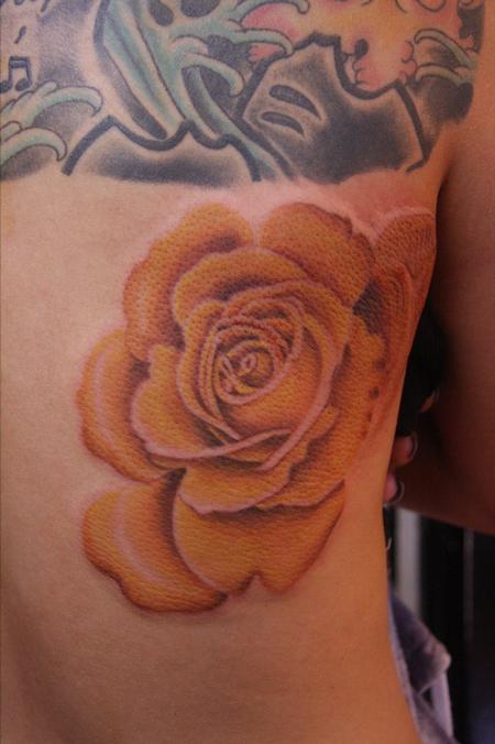 rose tattoo on ribs