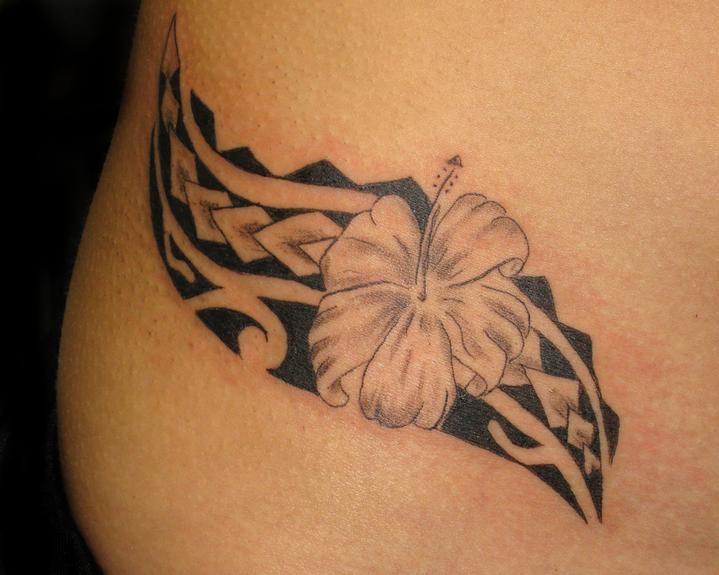 A nice little flower and tribal hip tattoo for this Hawaiian chica