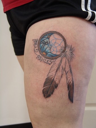Color dream catcher tattoo with a moon within the web