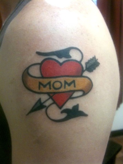 Traditional Sailor Jerry heart and scroll with Mom tattooed on upper arm