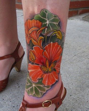 It is a nasturtium flower color leg tattoo that was a memorial piece for