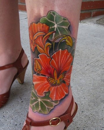 It is a nasturtium flower color leg tattoo that was a memorial piece for 