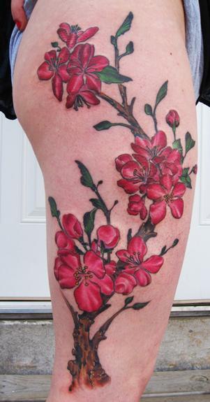 Pink cherry blossom with branch color leg girl tattoo