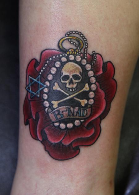 Mario Rosenau - colored flower with a skull and cross bones tattoo