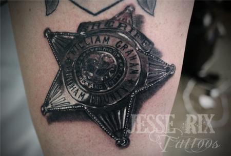 Jesse Rix - sheriff badge tattoo