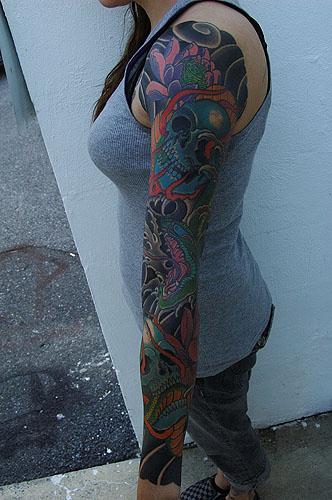 main view of snake sleeve with two flaming skulls and lotus flowers
