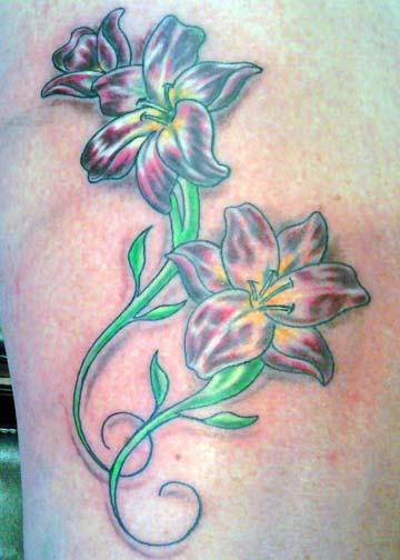 Aran Campas Lilies on thigh tattoo