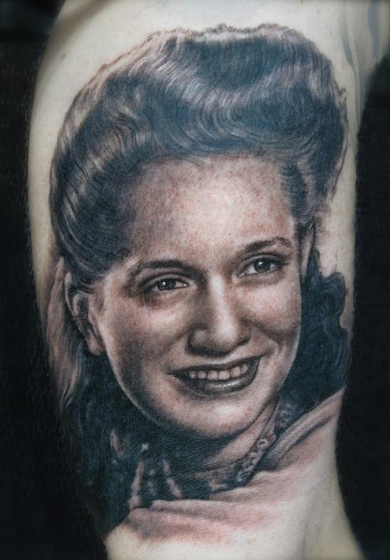 black and grey portrait of mom done on inner bicep