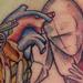 Sketchy Figure Holding Heart Grenade Tattoo Thumbnail