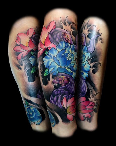 Cover up tattoo of Japanese flowers and an octopus tentacle