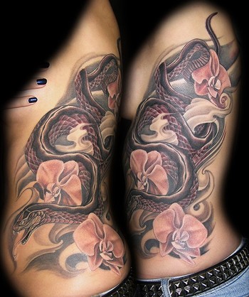 serpent tattoo. Snake down Ribs with Flowers