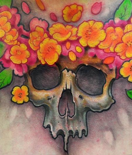 Skull and flowers chest tattoo detail