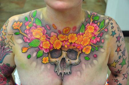Bez Skull and flowers chest tattoo