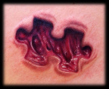 Kelly Doty - Jigsaw Skin Removal tattoo