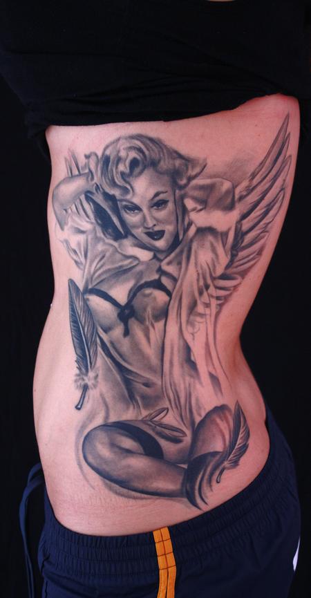 This black and grey pinup girl tattoo was asked to be turned in to a angel