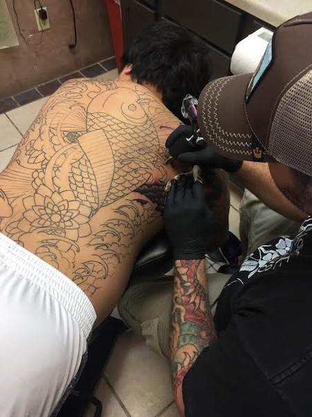 Tattoos - Chad working hard on this giant Koi back piece - 117710