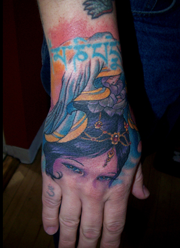Tom Strom - asian woman hand tattoo