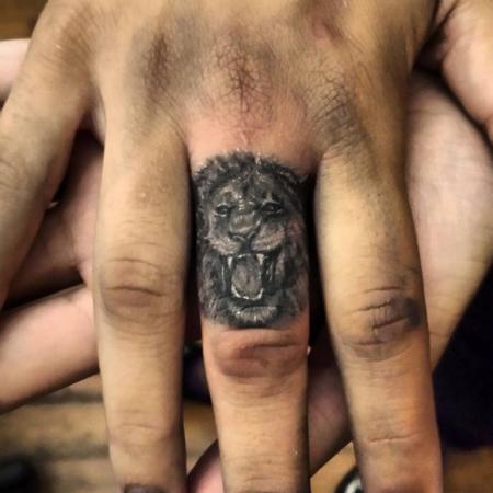 Haley Adams - lion finger tattoo